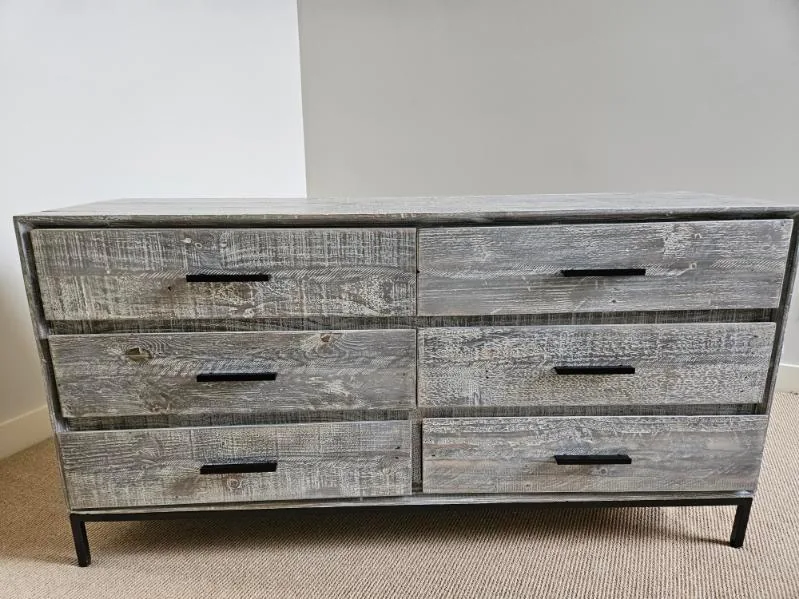 A wooden dresser inside a home before moving
